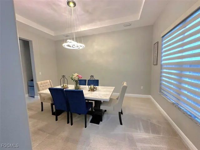 a view of a dining room with a table and chairs