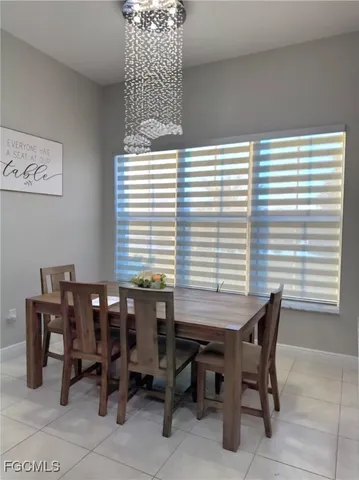 a view of a dining room with furniture and chandelier