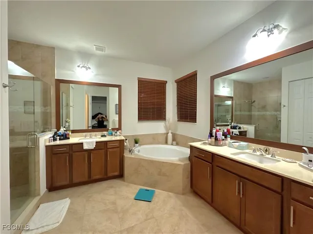 a large bathroom with a sink mirror and bathtub