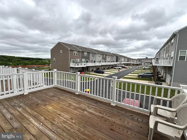 a view of balcony with wooden floor and fence