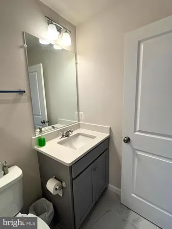 a bathroom with a sink toilet and mirror