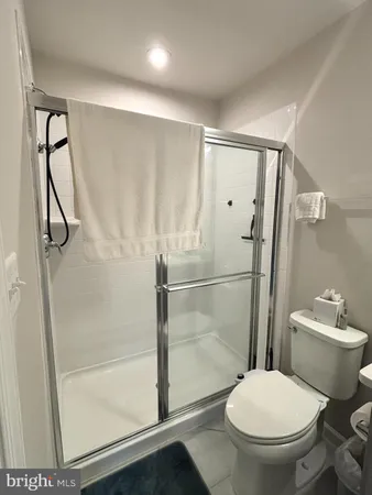 a white toilet sitting next to a bathroom sink