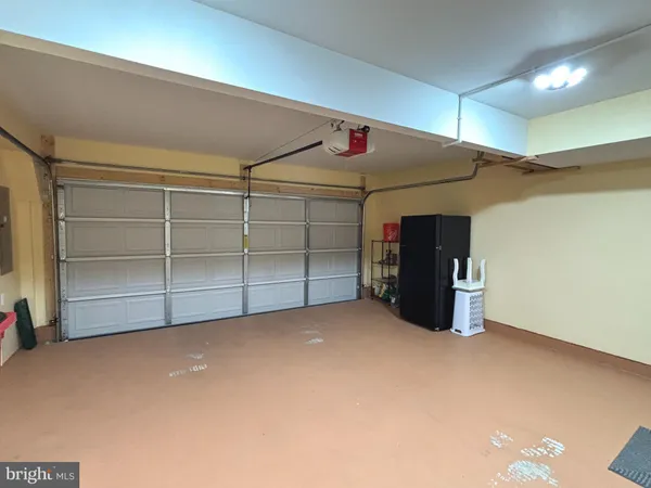 a view of an empty room with closet and a window