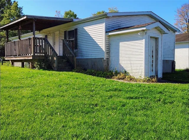 a view of backyard with small cabin and wooden fence