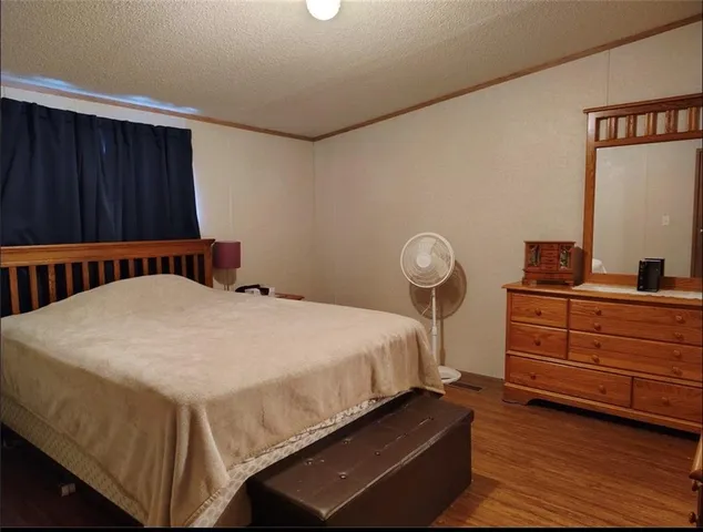 a living room with furniture a rug and a mirror