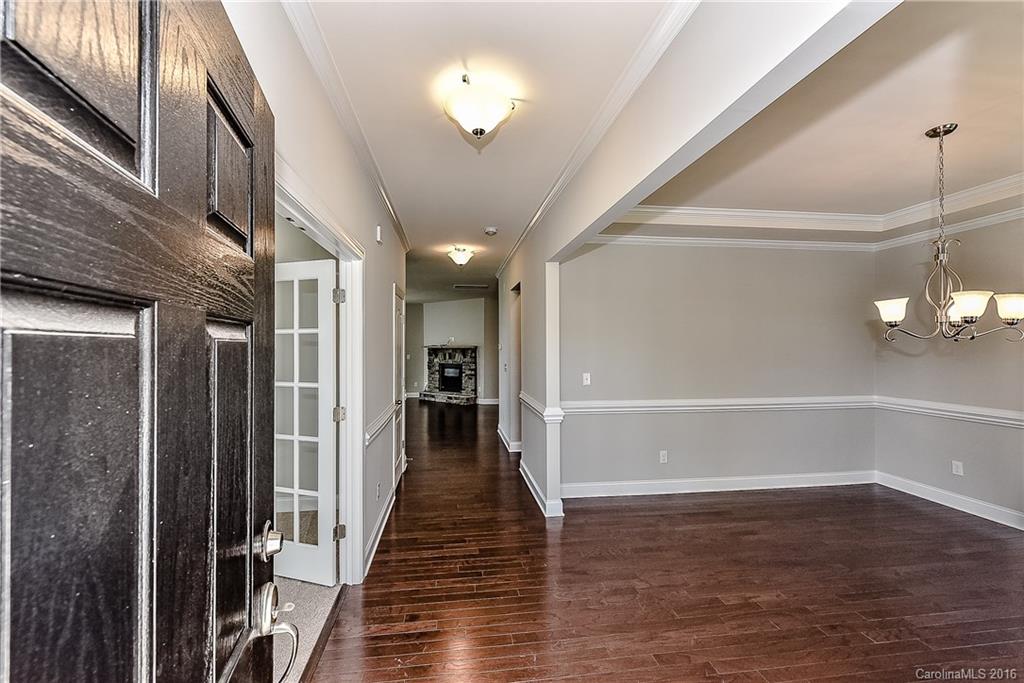 5157 Waterloo Drive, Unit CC151 Tega Cay, SC 29708 - Photo 2 of 21 a view of a hallway with wooden floor and staircase