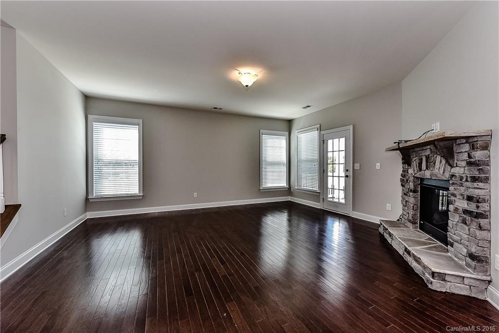 5157 Waterloo Drive, Unit CC151 Tega Cay, SC 29708 - Photo 11 of 21 a view of an empty room with wooden floor and a window