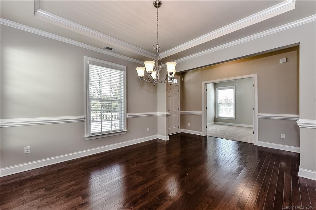 5157 Waterloo Drive, Unit CC151 Tega Cay, SC 29708 - Photo 12 of 21 a view of an empty room with wooden floor and a window