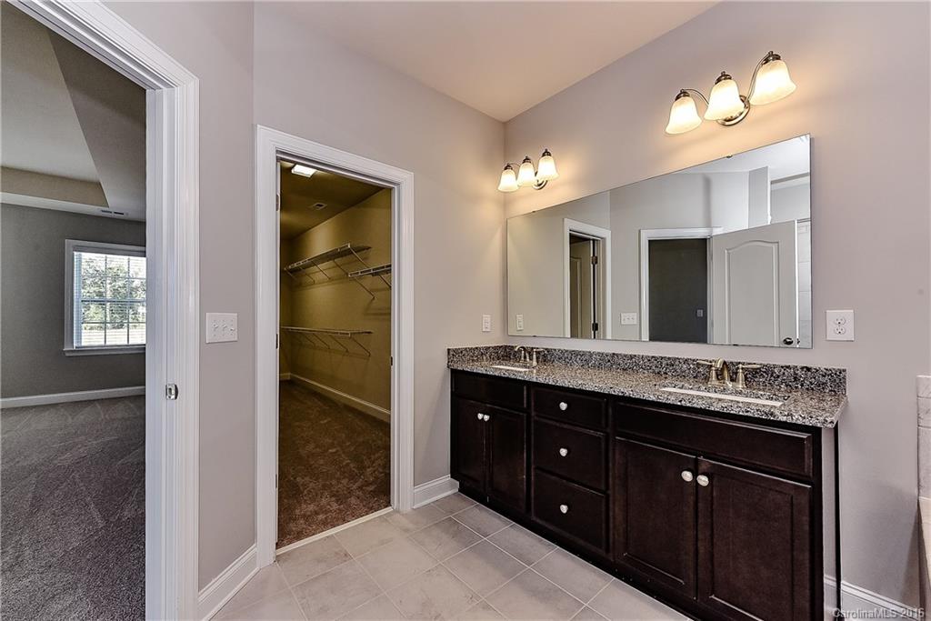 5157 Waterloo Drive, Unit CC151 Tega Cay, SC 29708 - Photo 18 of 21 a spacious bathroom with a double vanity sink and a mirror