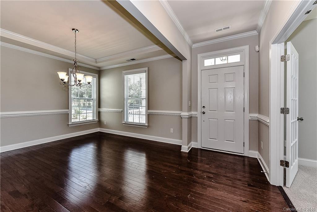 5157 Waterloo Drive, Unit CC151 Tega Cay, SC 29708 - Photo 3 of 21 a view of an empty room with wooden floor and a window