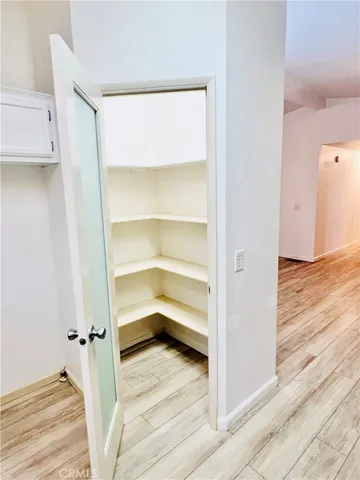 a kitchen with stainless steel appliances kitchen island granite countertop a refrigerator sink and white cabinets