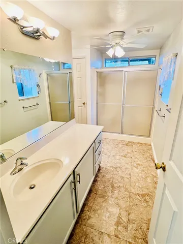 a bathroom with a sink a large mirror and a shower