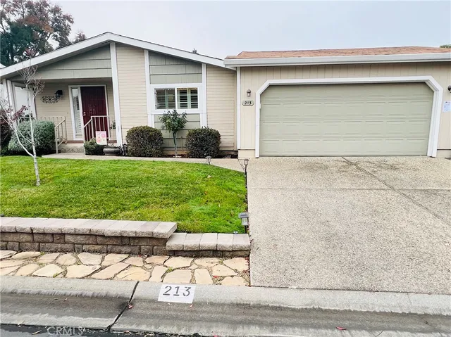 a view of a house with a yard and garage