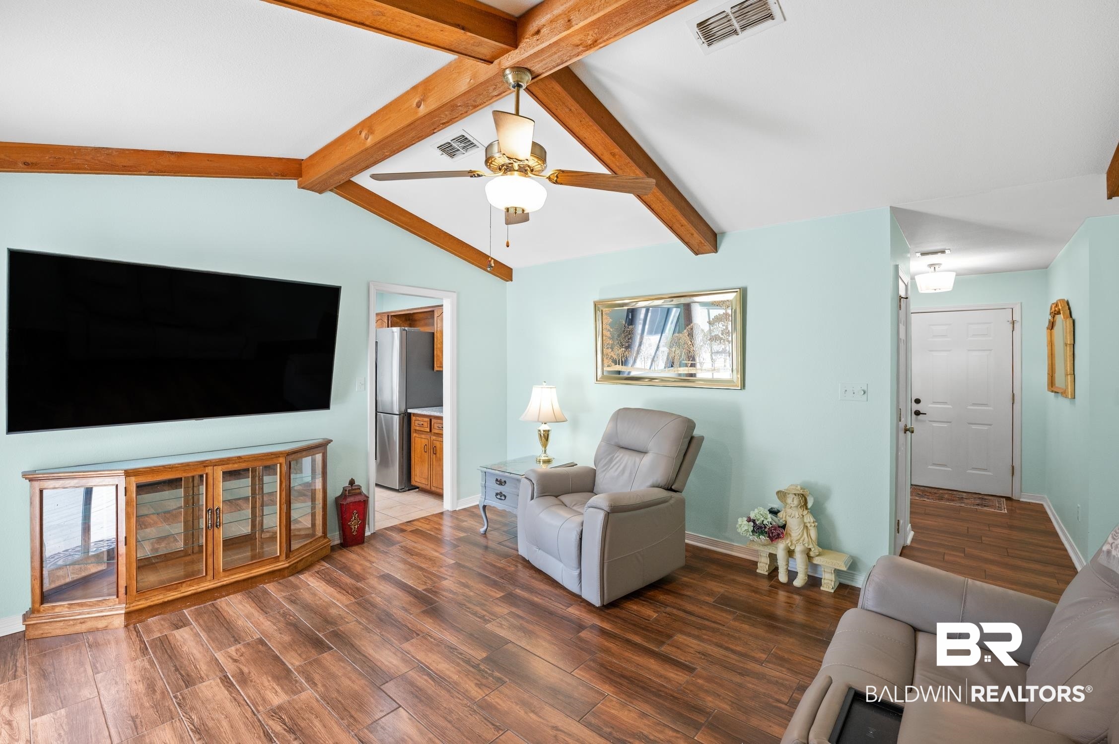 2553 Santa Rosa Drive Lillian, AL 36549 - Photo 7 of 51 Living area featuring dark wood-style floors, visible vents, and vaulted ceiling with beams