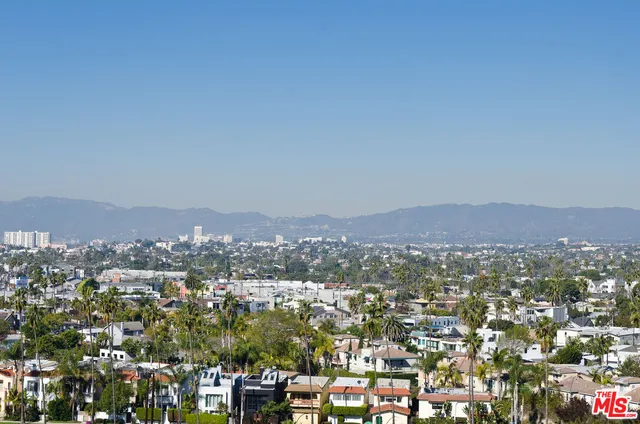 an aerial view of residential houses with city view