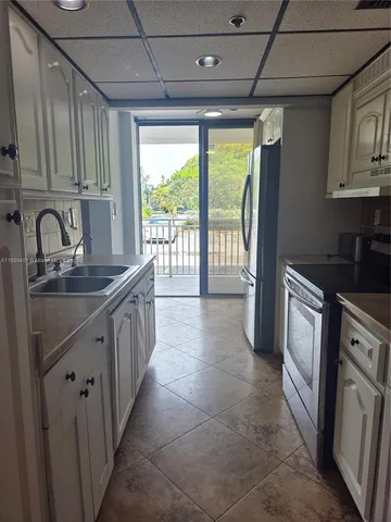 a kitchen that has a sink and a stove