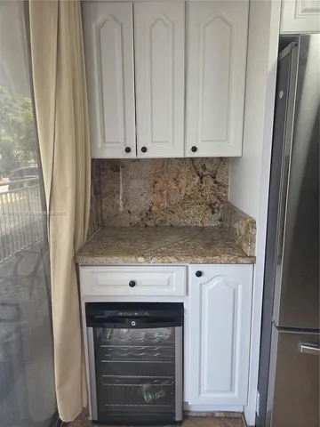 a metallic refrigerator freezer sitting in a kitchen