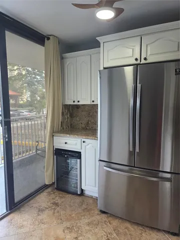 a kitchen with a stove a refrigerator and a sink