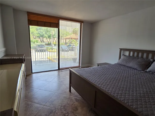 a bedroom with a bed and painting on the wall