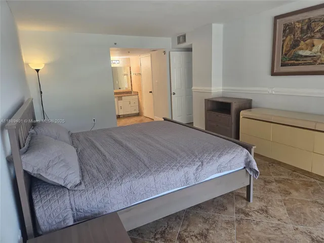 a bedroom with a bed and a table in it