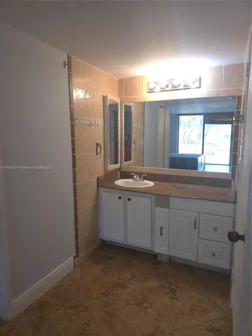 a bathroom with a toilet a sink and a mirror