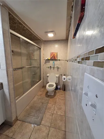 a spacious bathroom with a sink mirror and shower