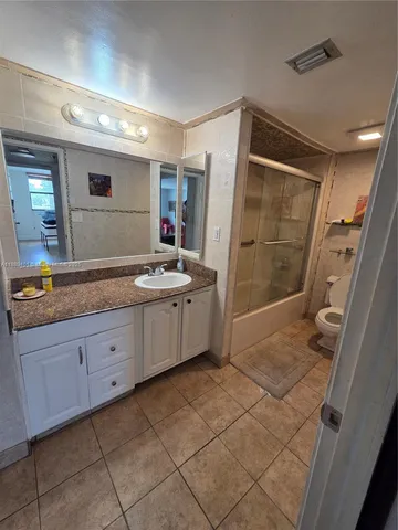 a bed sitting in a room next to a window