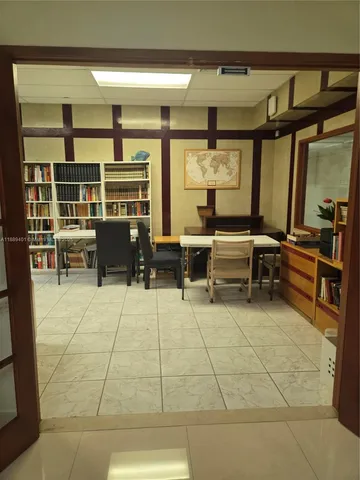 a front view of a multi story building with yard