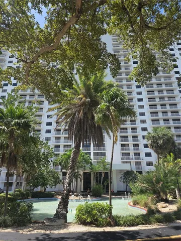 a picture of a building with a tree in front