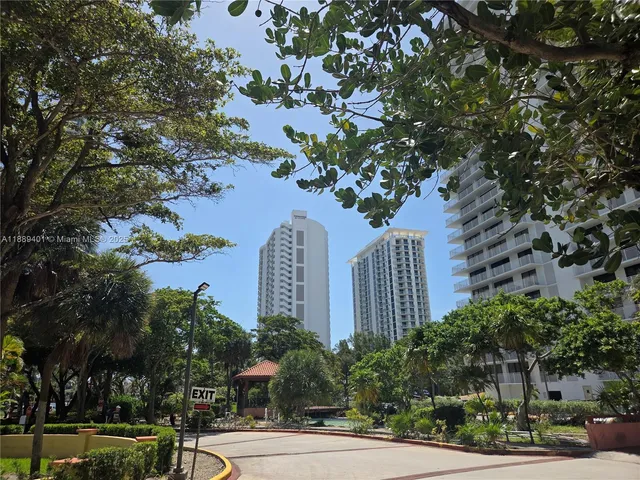 a front view of a residential apartment building with a yard