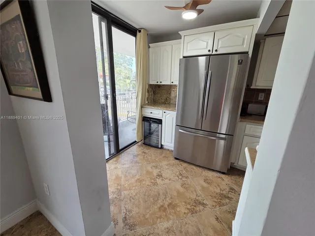 a kitchen with a refrigerator and a stove top oven