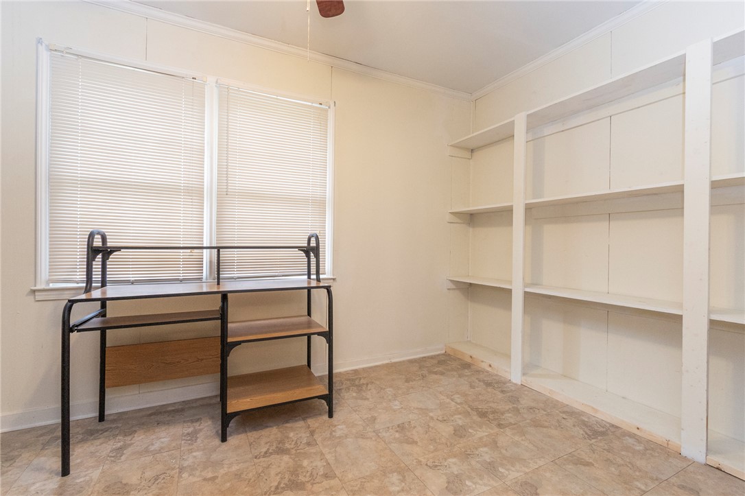 1116 Leatherdale Road Iva, SC 29655 - Photo 31 of 46 This versatile room features expansive shelving and ample natural light, ideal for a home office or creative space.