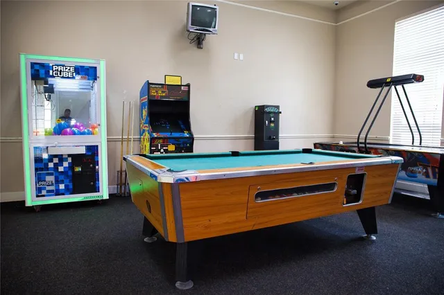 a room with pool table and window