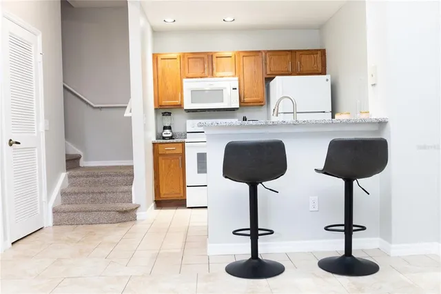 a kitchen with stainless steel appliances kitchen island a chandelier