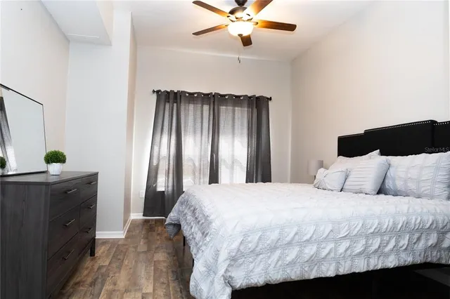 a bedroom with a bed and a chandelier