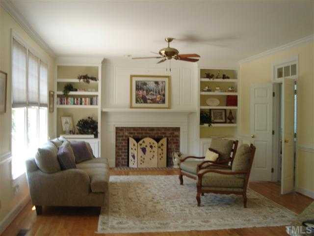 4307 Thetford Road Durham, NC 27707 - Photo 7 of 25 Family room graced with gas log fireplace, built-in bookcases, and bathed in light. Den/Family/Great Room