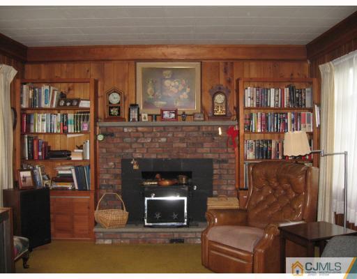 306 New Market Road Dunellen, NJ 08812 - Photo 2 of 10 a living room with furniture and a fireplace
