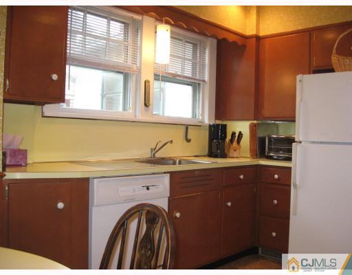 306 New Market Road Dunellen, NJ 08812 - Photo 5 of 10 a kitchen with a sink a refrigerator and cabinets