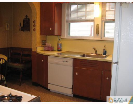 306 New Market Road Dunellen, NJ 08812 - Photo 7 of 10 a kitchen with a sink cabinets and a window