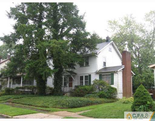 306 New Market Road Dunellen, NJ 08812 - Photo 8 of 10 a front view of a house with a yard