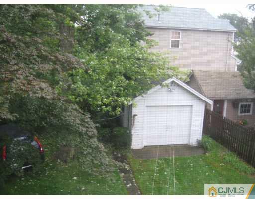 306 New Market Road Dunellen, NJ 08812 - Photo 9 of 10 a view of backyard of house with green space