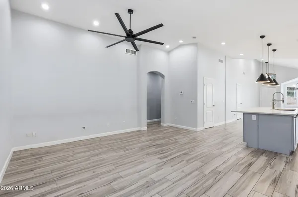 a view of a kitchen with wooden floor and a sink