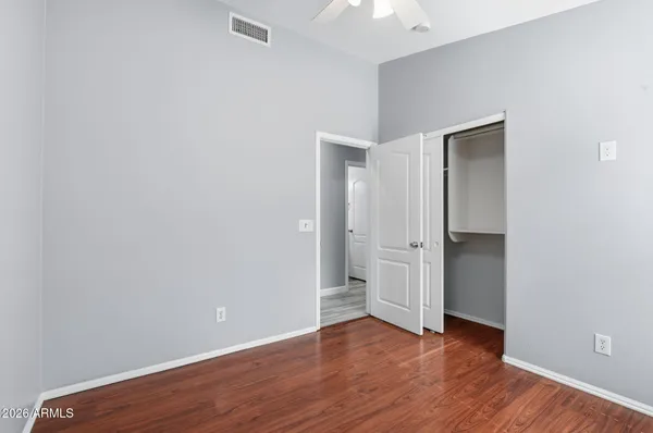 a view of an empty room with wooden floor