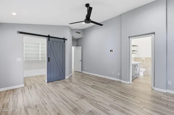 a view of an empty room and wooden floor