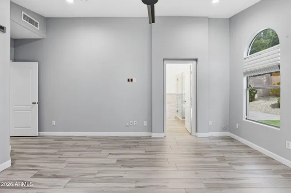 a view of room with window and wooden floor