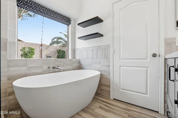 a white bath tub sitting in a bathroom