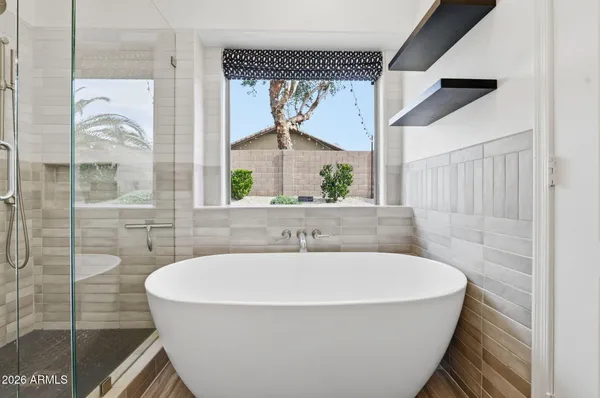 a bathroom with a bathtub and a shower