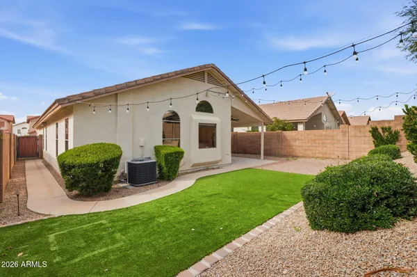 a front view of a house with a yard and potted plants