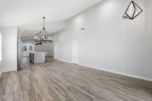 a view of a room with wooden floor white walls and stairs