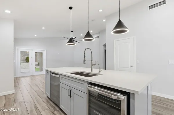 a kitchen with kitchen island a sink and wooden floor